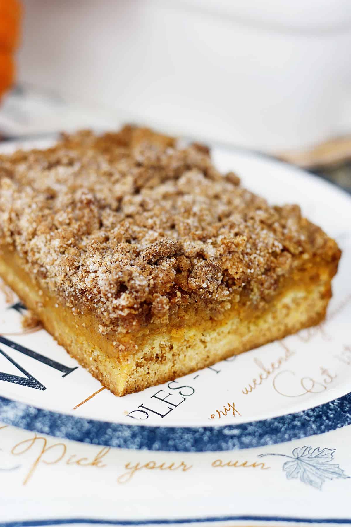 A slice of pumpkin crumb cake on a paper plate.