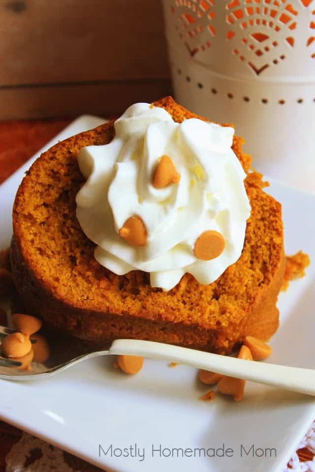A slice of pumpkin Bundt cake on a white square plate with a fork next to it