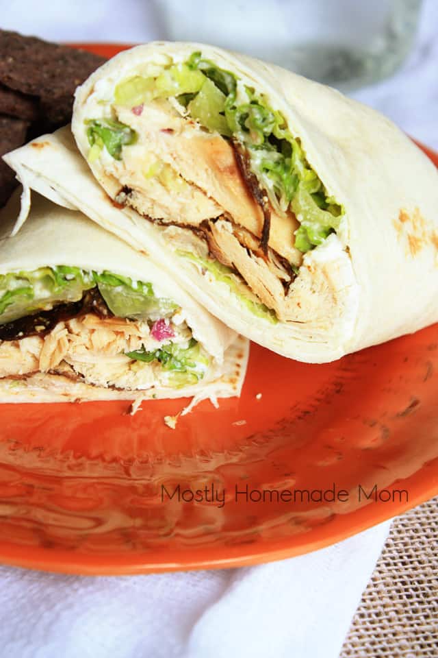 A chicken caesar wrap sliced and stacked on top of each other on a plate