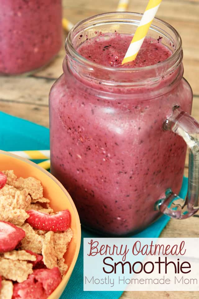 A mason jar full of berry oatmeal smoothie with a yellow striped straw