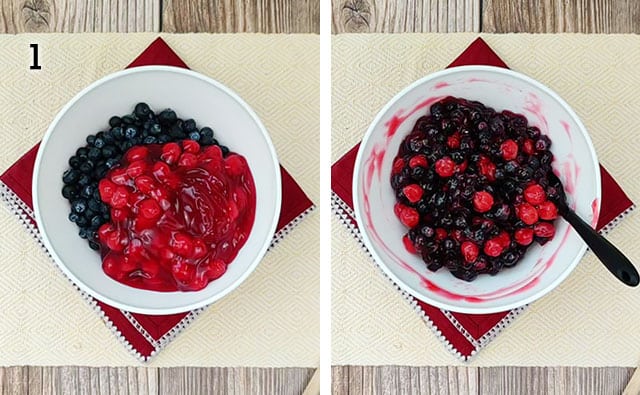 Mixing blueberries and cherry pie filling in a white mixing bowl