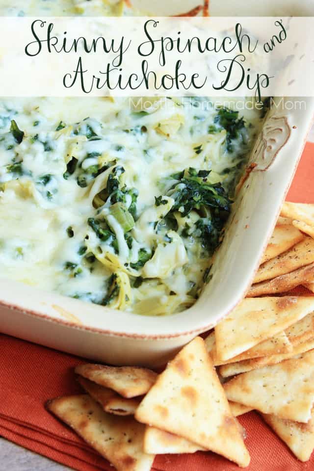 Skinny spinach artichoke dip without mayo in a square baking dish next to pita chips