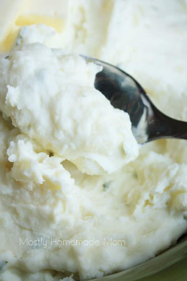 A spoon scooping some mashed potatoes