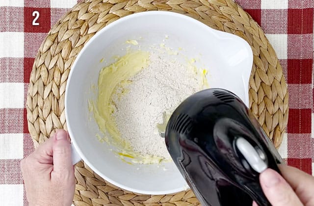 Adding flour mixture to sugar mixture with an electric beater