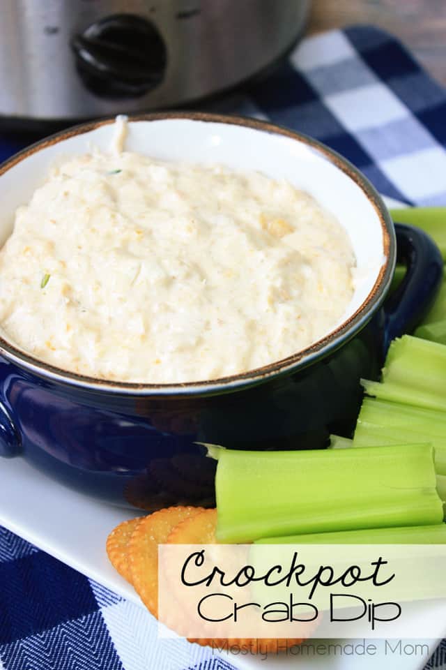 Hot crab dip in a bowl with crackers and celery sticks