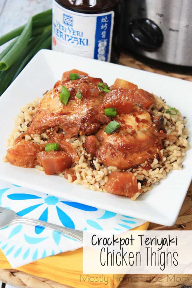 Teriyaki chicken with pineapple and green onion over rice on a plate