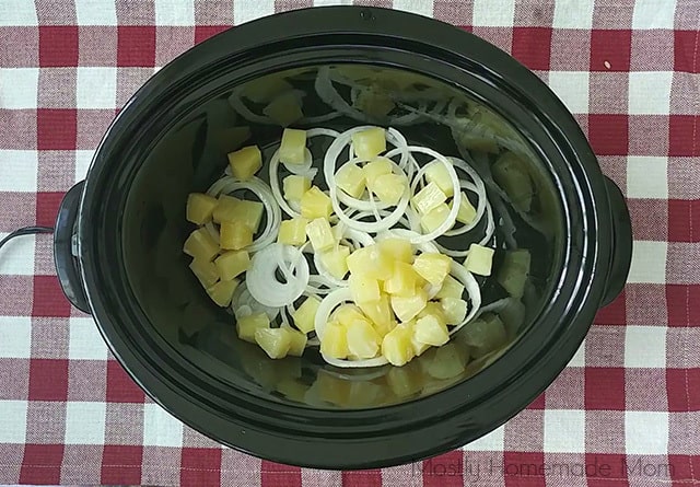 Sliced onions and pineapple in a Crock pot