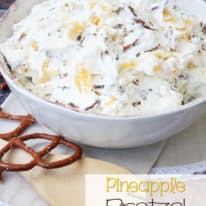 A bowl of pineapple pretzel salad with a wooden mixing spoon next to it