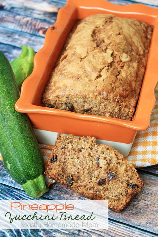 Pineapple zucchini bread loaf in a baking dish next to a zucchini