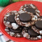 A red plate filled with peppermint patty cookies stacked