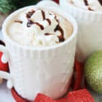 A white mug with eggnog hot chocolate.