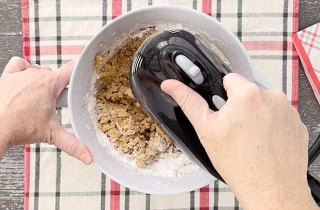 Add in powdered sugar to a mixing bowl using a hand mixer