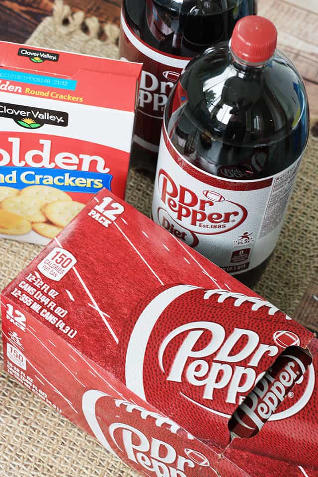 Dr Pepper soda cans and 2 liter bottles and a box of Clover Valley crackers