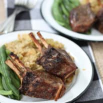 Two plates of baked lamb chops with green beans and stuffing