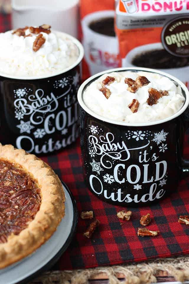 Two mugs of pecan pie coffee topped with whipped cream