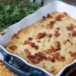 Jalapeno popper dip in a blue baking dish with crackers