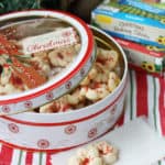 Almond cream cheese spritz cookies in a tin ready to be given as a gift