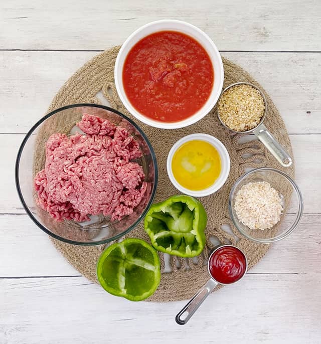 Ingredients for meatloaf stuffed peppers with no rice on a placemat