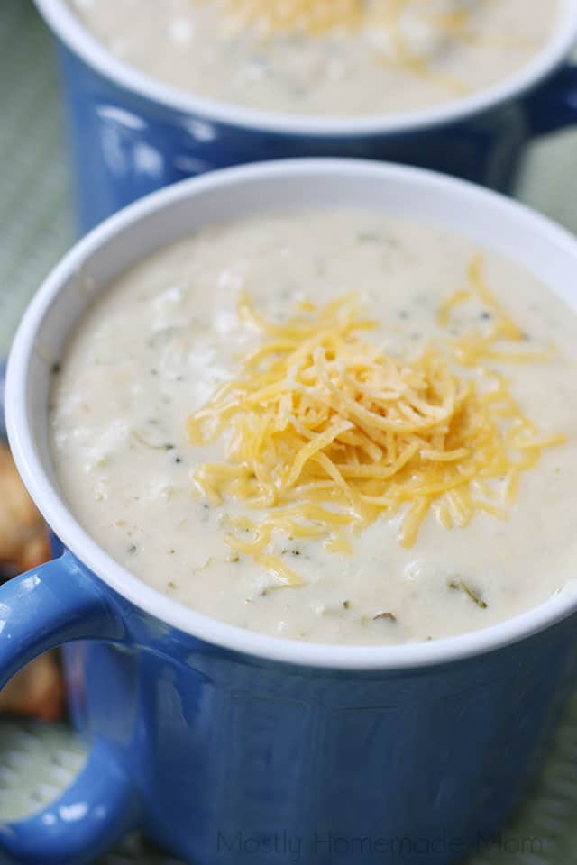 A bowl of cream of broccoli soup recipe topped with shredded cheese