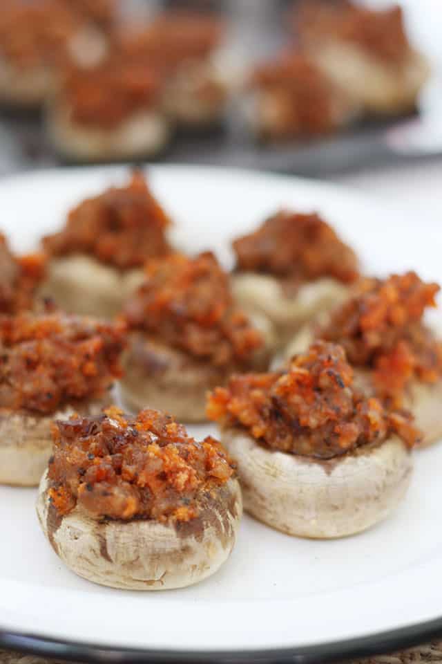 Sausage stuffed mushrooms on a white plate