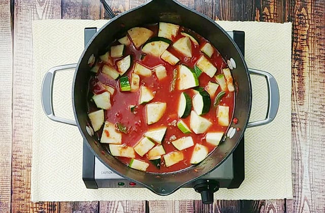 Zucchini soup cooking in a pot on a skillet
