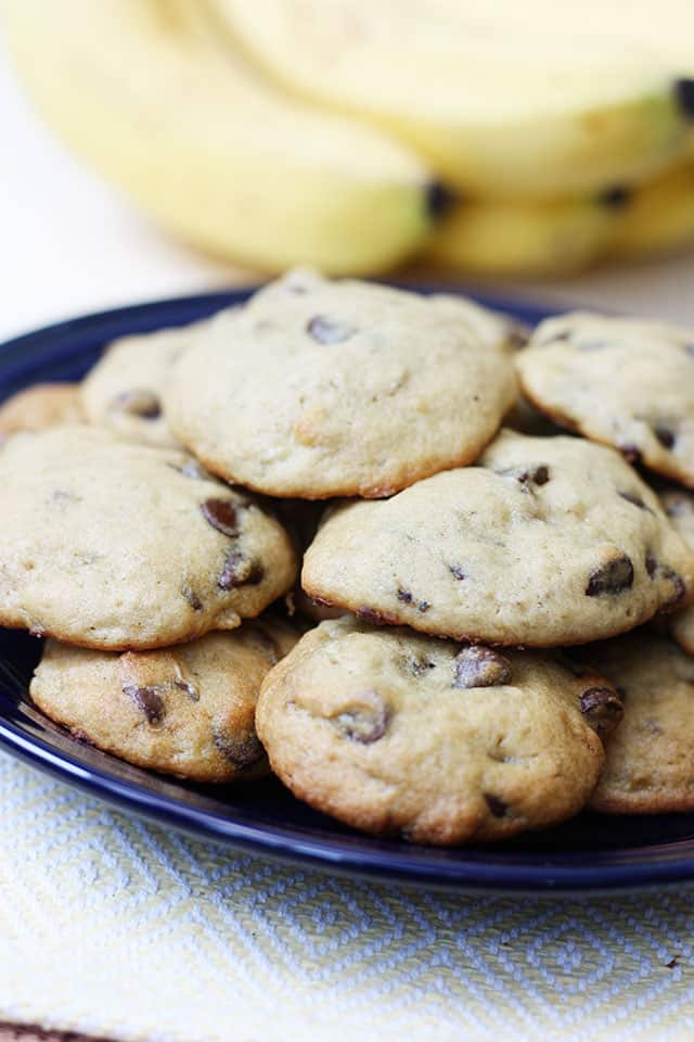 Banana chocolate chip cookies piled together on a blue plate