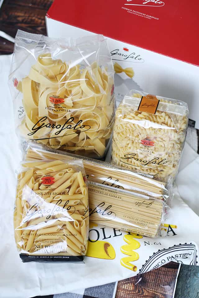 Bags of pasta sitting on a white apron