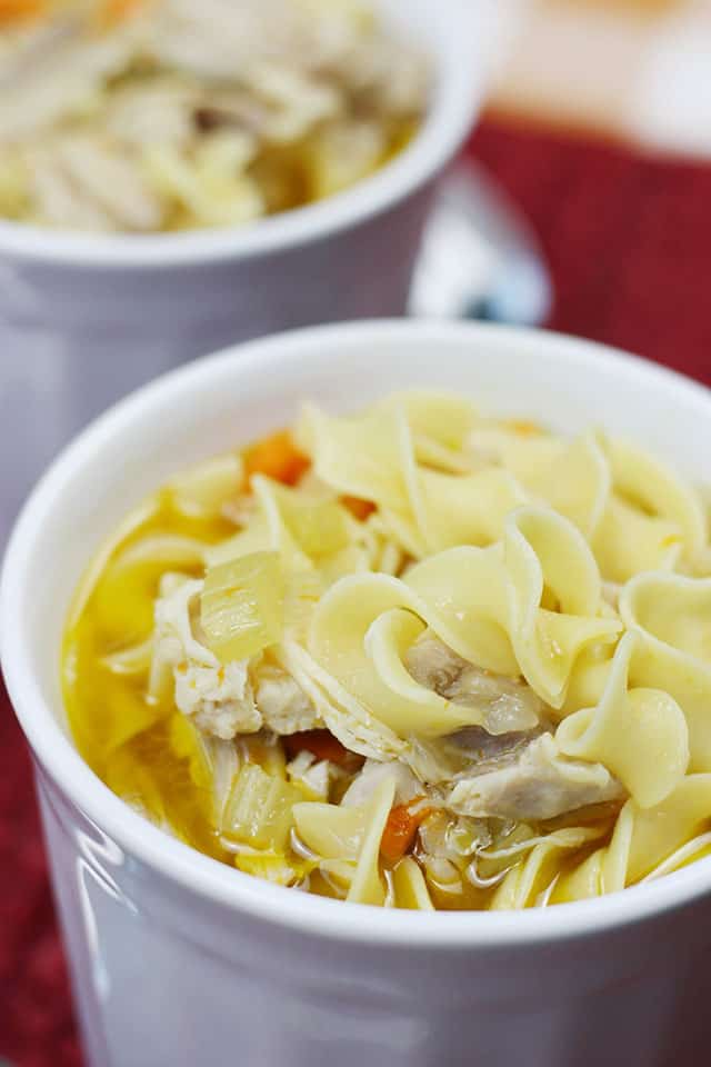 Best chicken noodle soup recipe in a white soup mug