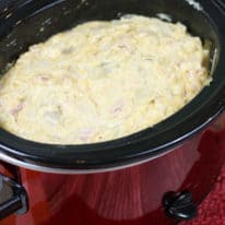 Slow cooker scalloped potatoes in a red crockpot