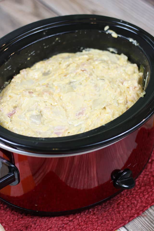 Slow cooker scalloped potatoes in a red crockpot