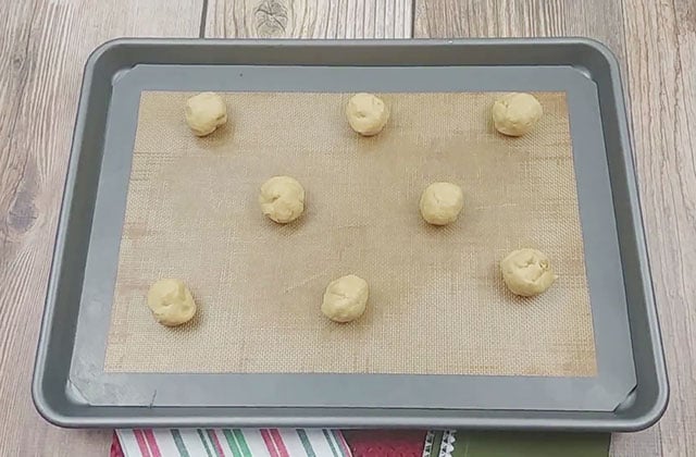 Peanut butter chip cookies on a cookie sheet waiting to be baked in the oven