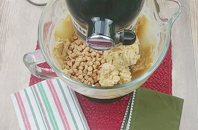 Stirring in peanut butter chips to peanut butter cookie dough in a stand mixer