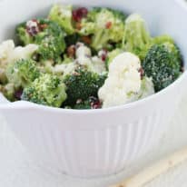 Broccoli Cauliflower salad in a white mixing bowl