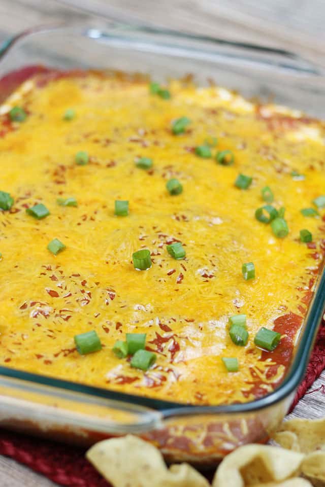 Taco dip recipe in a glass baking dish with tortilla chips