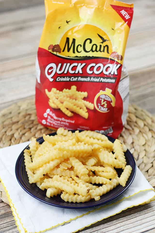 McCain Quick Cook Crinkle Cut fries on a blue plate on a placemat