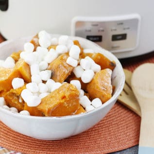Crockpot sweet potato casserole in a white bowl in front of a white Crockpot